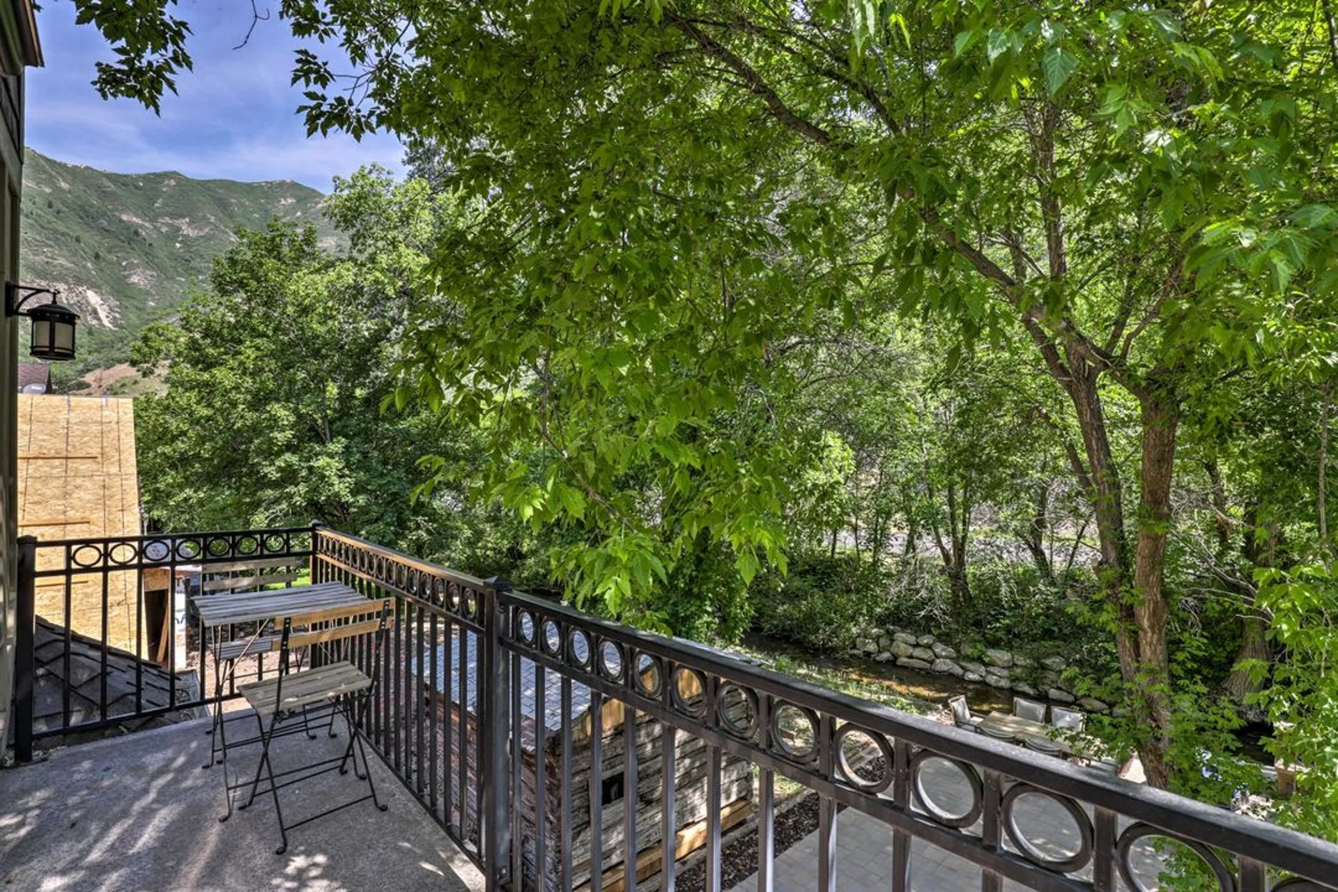 Private balcony with bistro seating overlooking the mountain creek and canyon walls