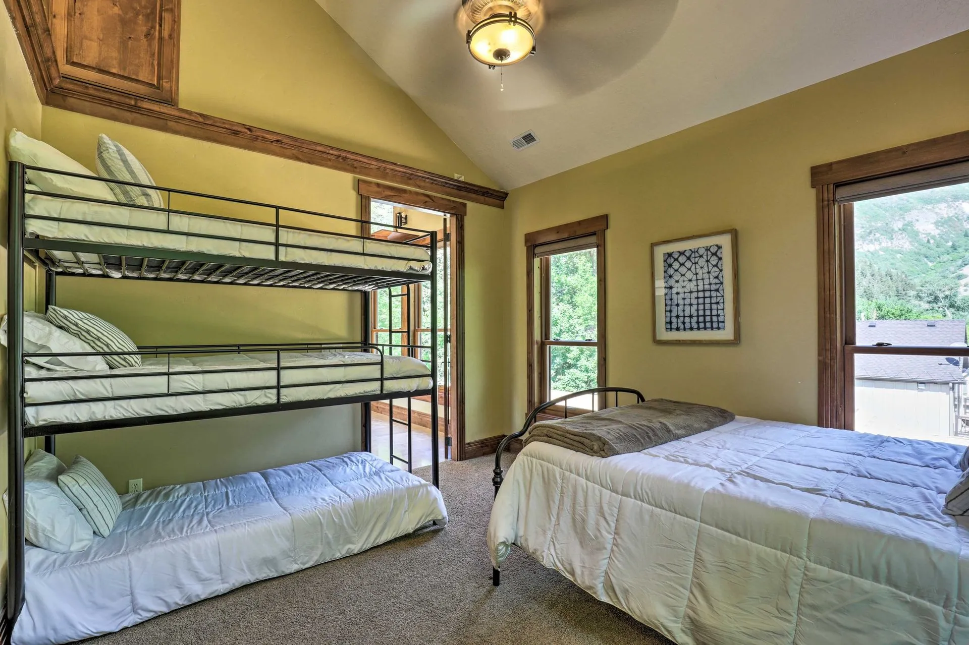 Bunk room with bunk beds and an additional bed, ideal for kids