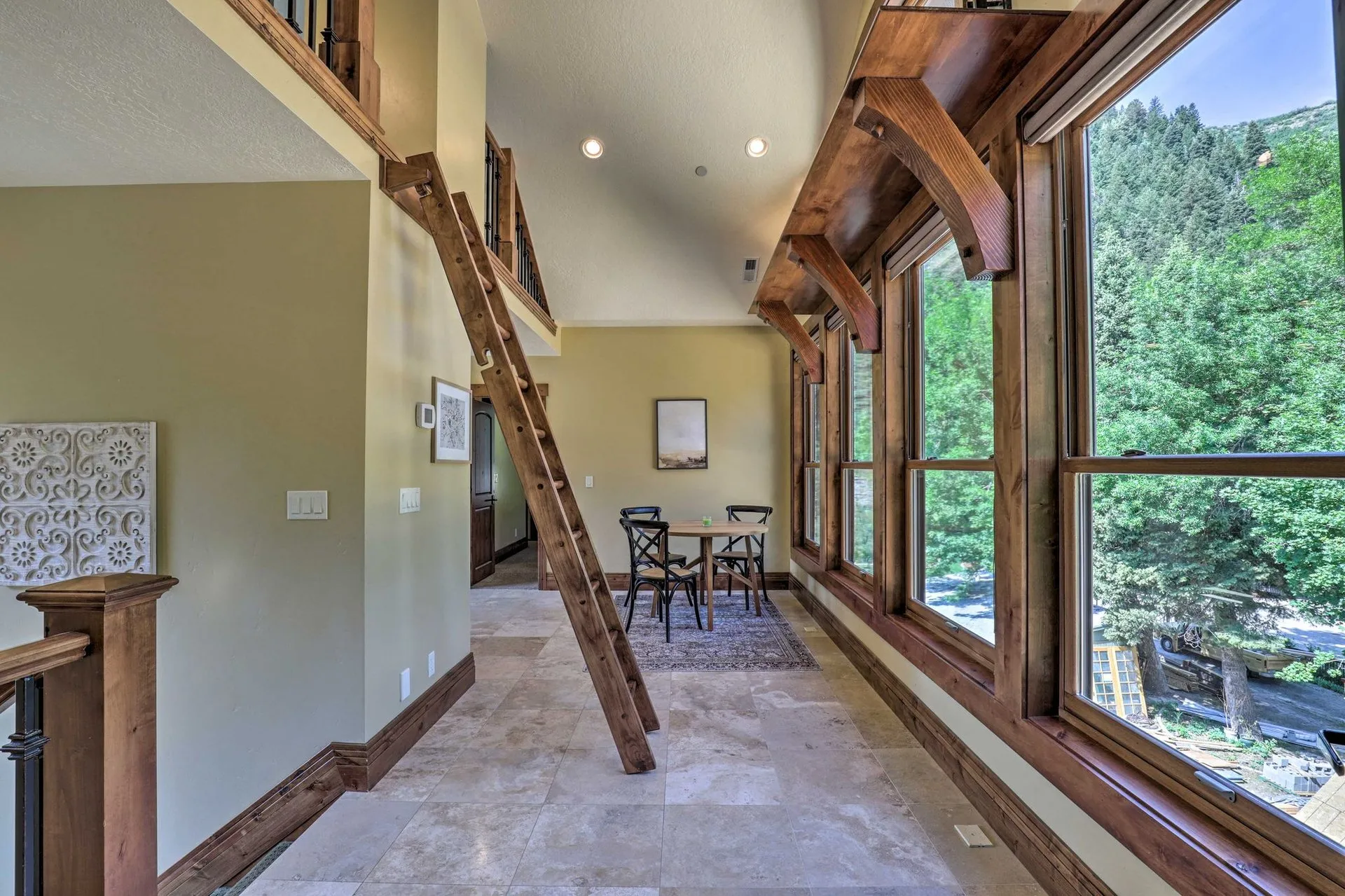 Upstairs loft landing with floor-to-ceiling windows overlooking the Provo Canyon treetops